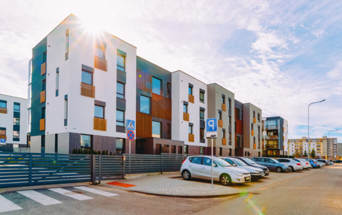 Apartment house and home residential building complex real estate concept. And street car parking. And the sunset