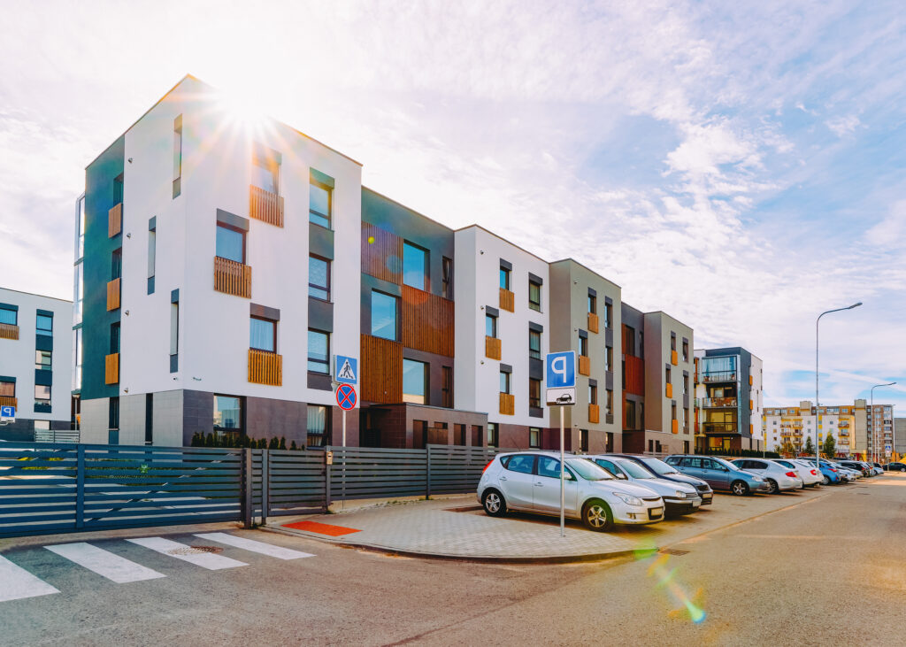 Apartment house and home residential building complex real estate concept. And street car parking. And the sunset